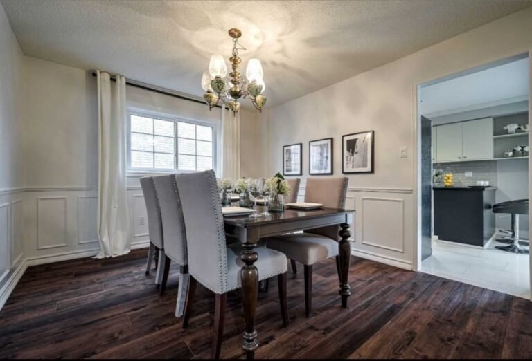 Completed dining room renovation with wall moulding and wood flooring